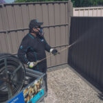 man cleaning fence1